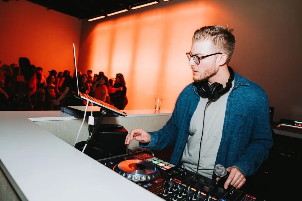 DJ MDDLCHLD at the DJ booth with packed dance floor