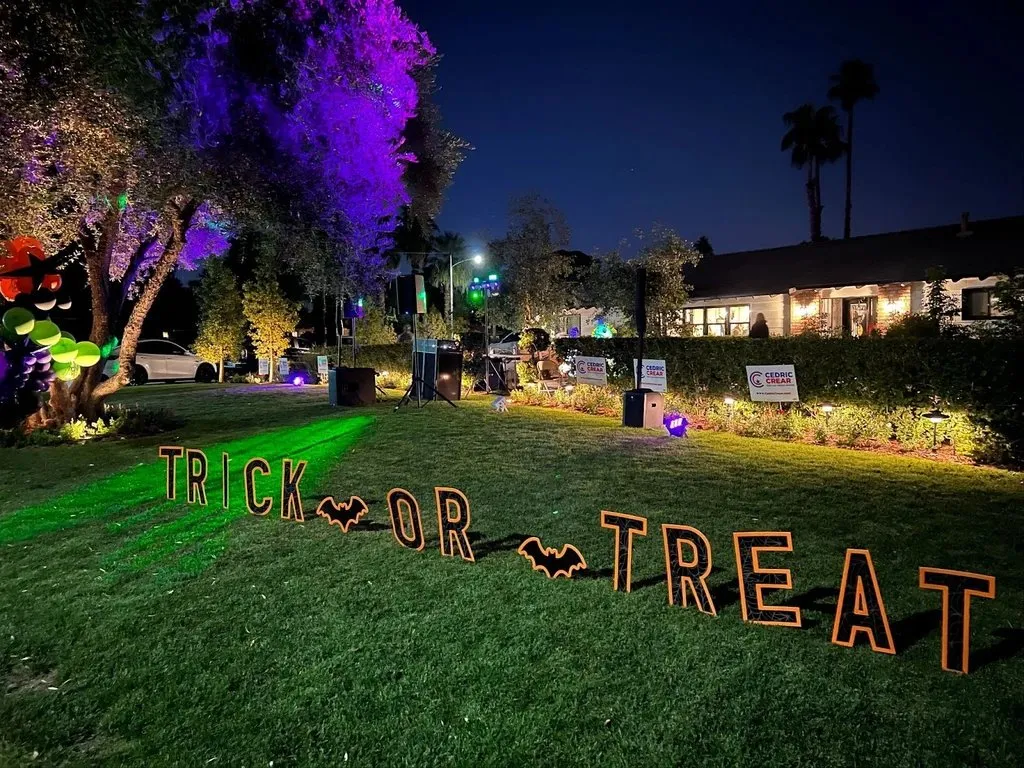 Halloween Trick or Treat outdoor event with colorful lighting
